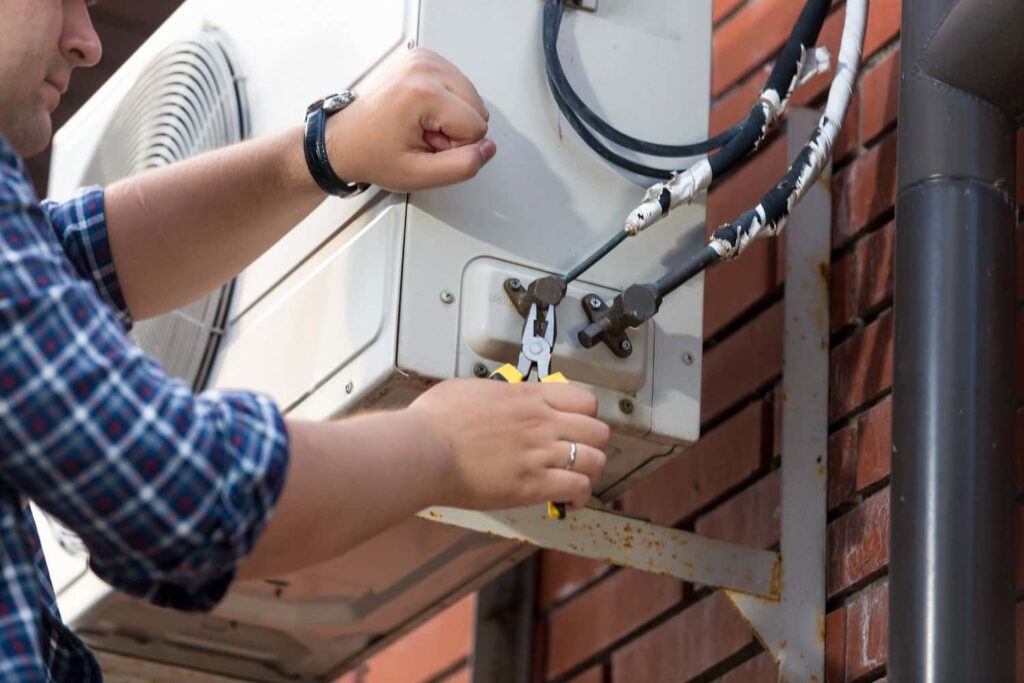 Closeup of male technician repairing outdoor air c 2021 12 09 17 34 31 utc min min.jpg