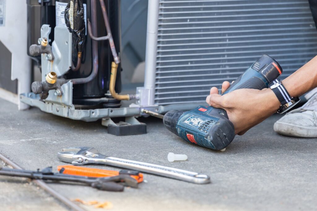 HVAC contractor repairing air conditioning system in Toms River, NJ.